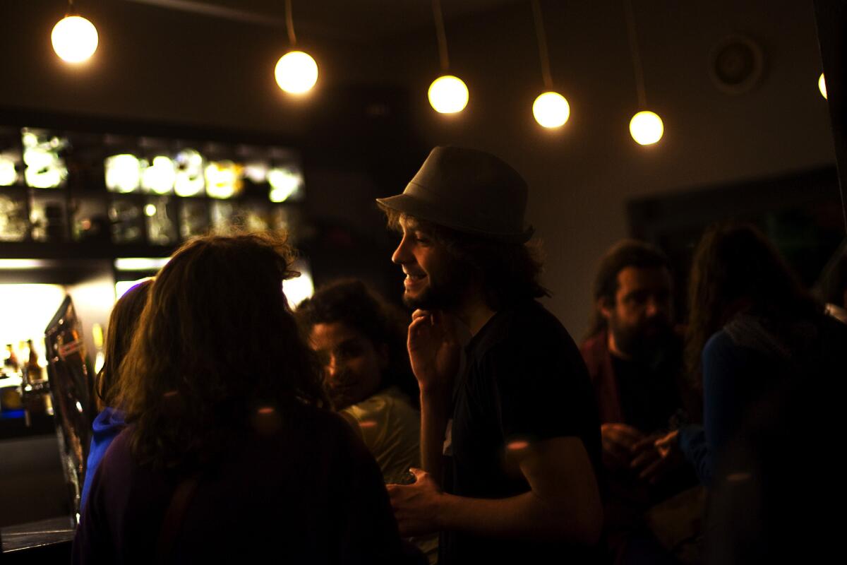 A foreign patron talks with friends at a bar in Ramallah in the West Bank.