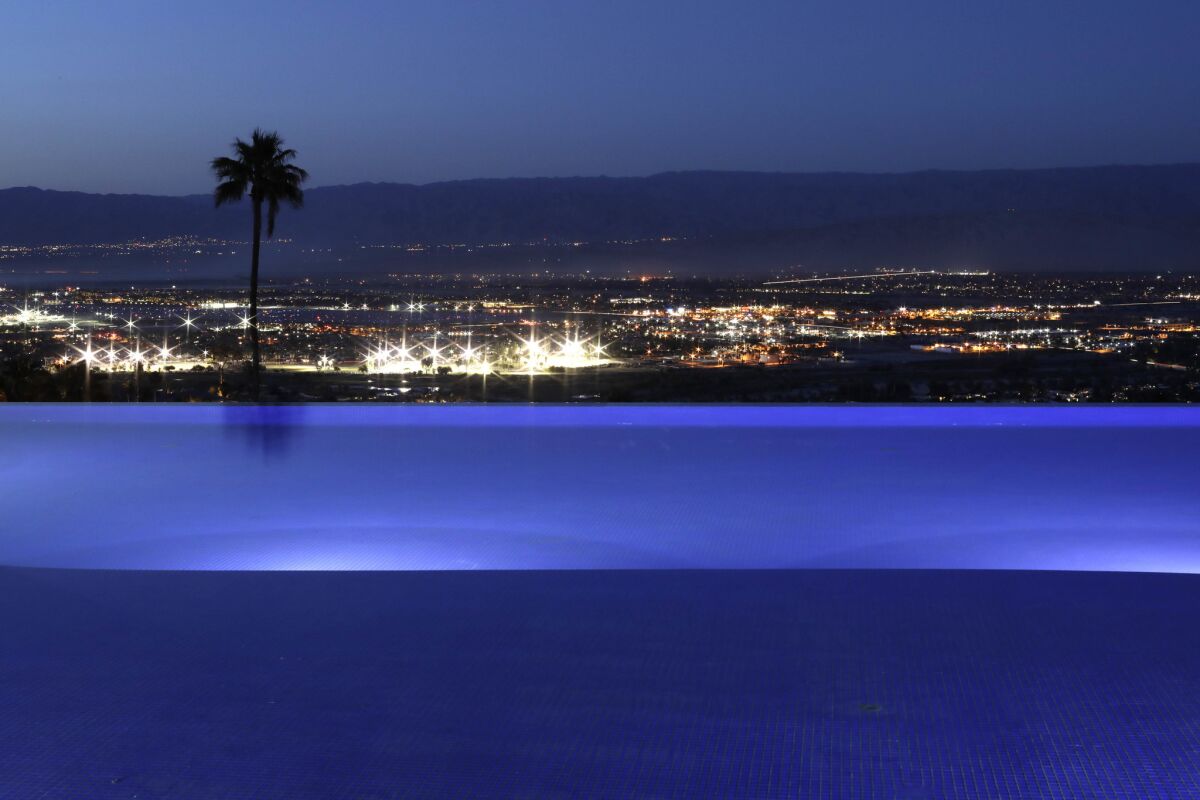 The twinkling lights of Palm Springs from the pool at the Bob Hope house. (Myung Chun / Los Angeles Times)