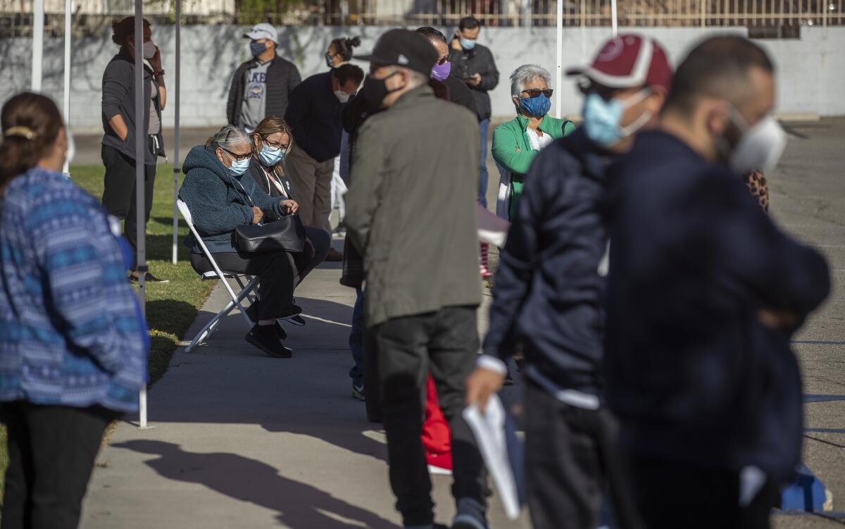 People wait for the COVID-19 vaccine.