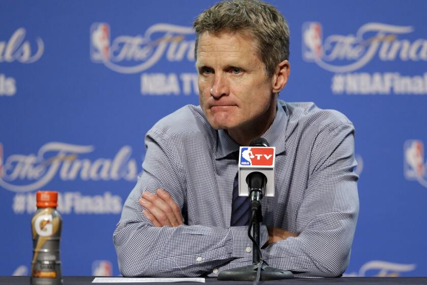 Golden State Coach Steve Kerr listens to a question during a news conference following Game 3 of the NBA Finals in Cleveland on June 10, 2015.