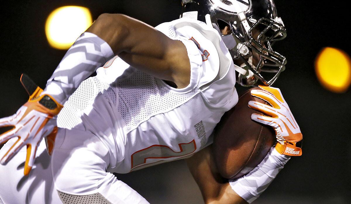 Bishop Gorman High receiver Cordell Broadus returns a kick against Servite during a game last season at Cerritos College.