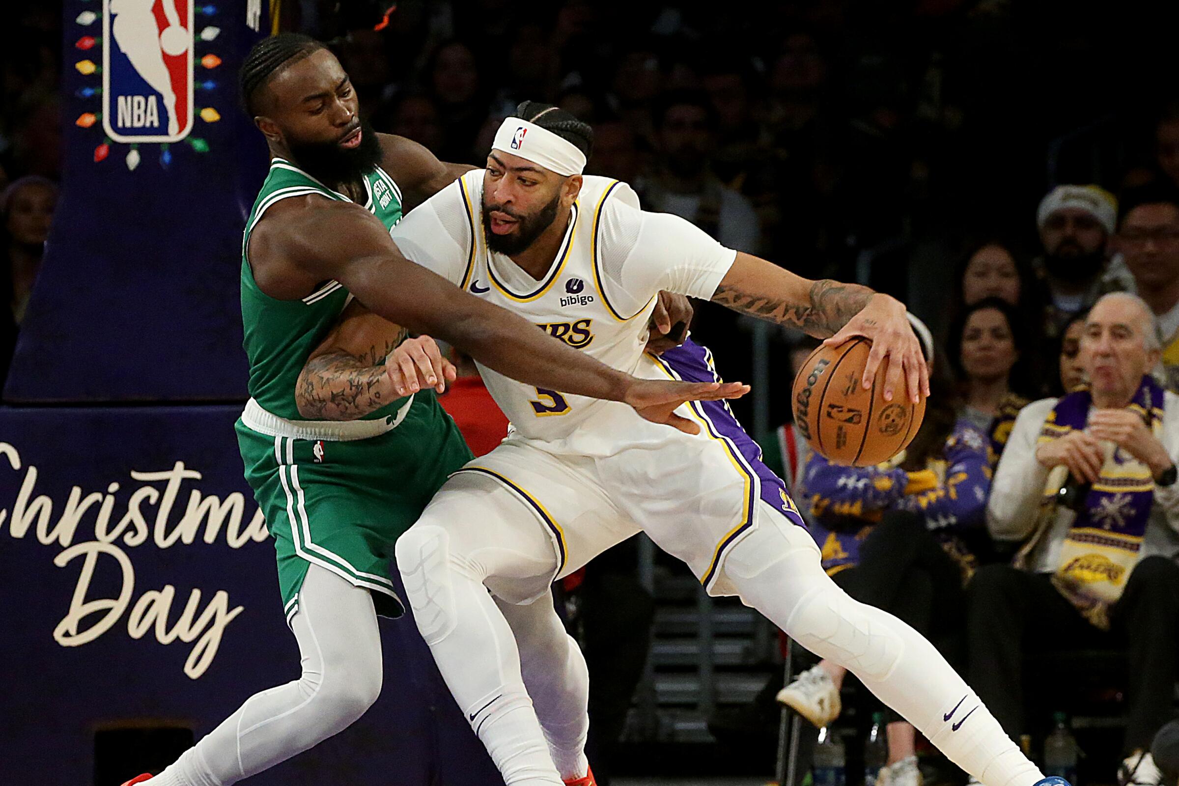 Lakers forward Anthony Davis drives to the basket against Celtics forward Jaylen Brown.