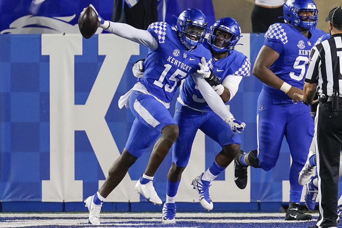 Kentucky linebacker Jordan Wright (15) celebrates after scoring a touchdown during the second half of the team's NCAA college football game against Mississippi State, Saturday, Oct. 10, 2020, in Lexington, Ky. (AP Photo/Bryan Woolston)