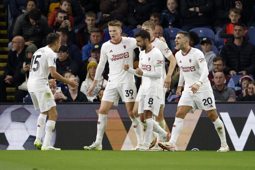 Manchester United's Bruno Fernandes, 2nd right, celebrates with teammates after scoring their sides first goal , during the English Premier League soccer match between Burnley and Manchester United at Turf Moor, in Burnley, England, Saturday, Sept. 23, 2023. (Richard Sellers/PA via AP)