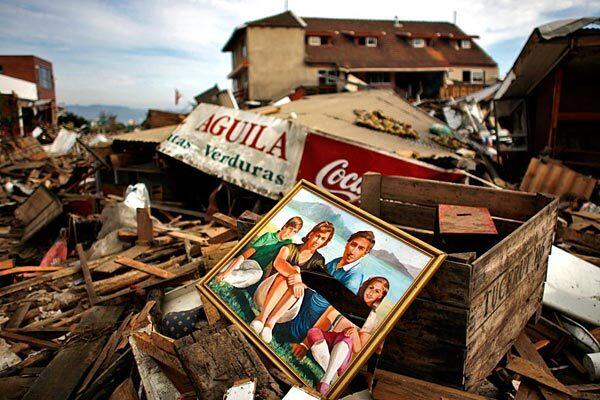 A painting lies amid the ruins of a home in Dichato, a small beach enclave where 17 people died and as many as 50 are missing.
