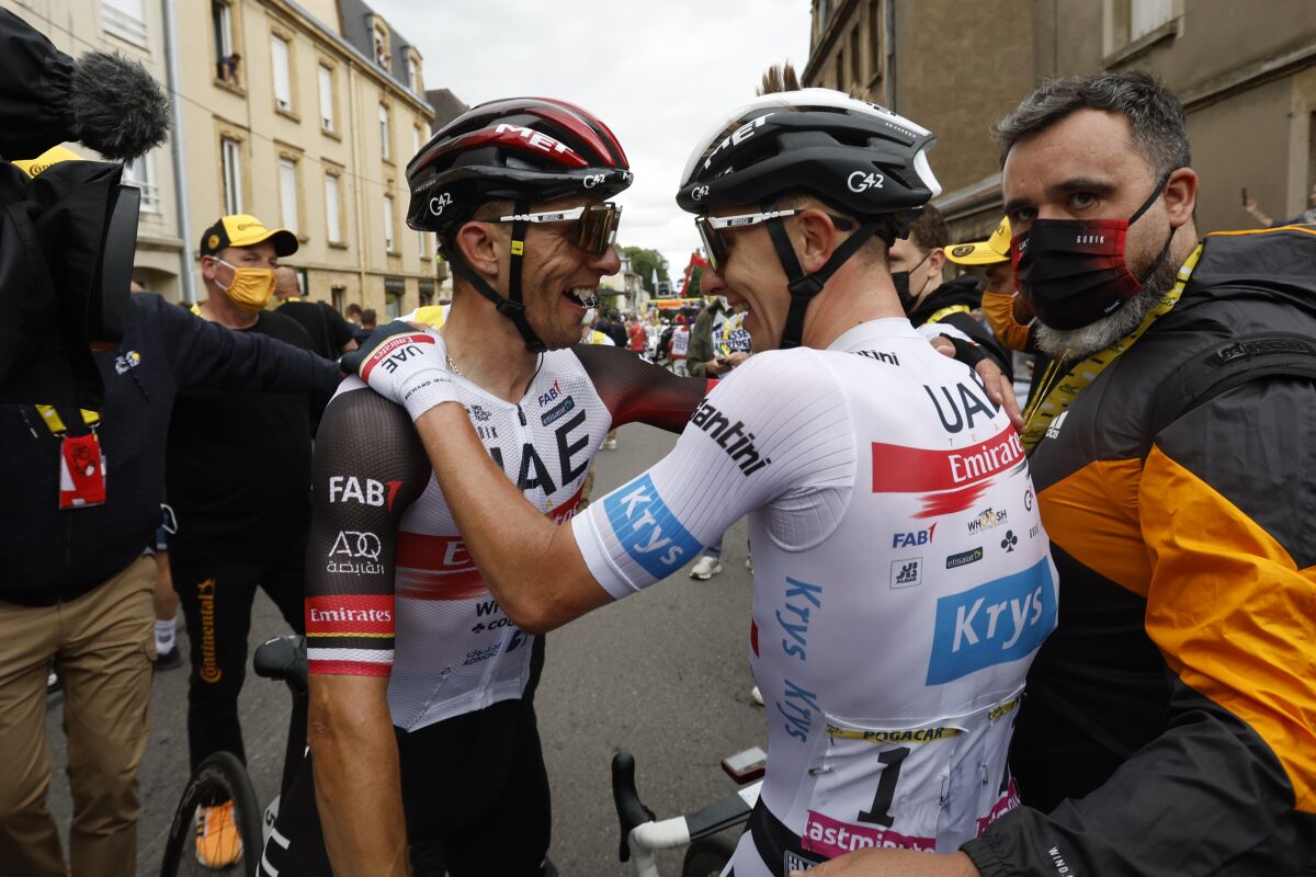 Slovenia's Tadej Pogacar, wearing the best young rider's white jersey celebrates with Poland's Rafal Majka after winning the sixth stage of the Tour de France cycling race over 220 kilometers (136.7 miles) with start in Binche and finish in Longwy, France, Thursday, July 7, 2022. (Gonzalo Fuentes/Pool via AP)
