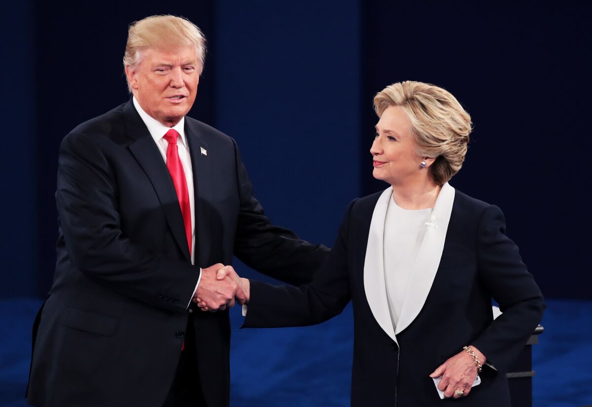 Donald Trump and Hillary Clinton shake hands at the end of their town hall debate.