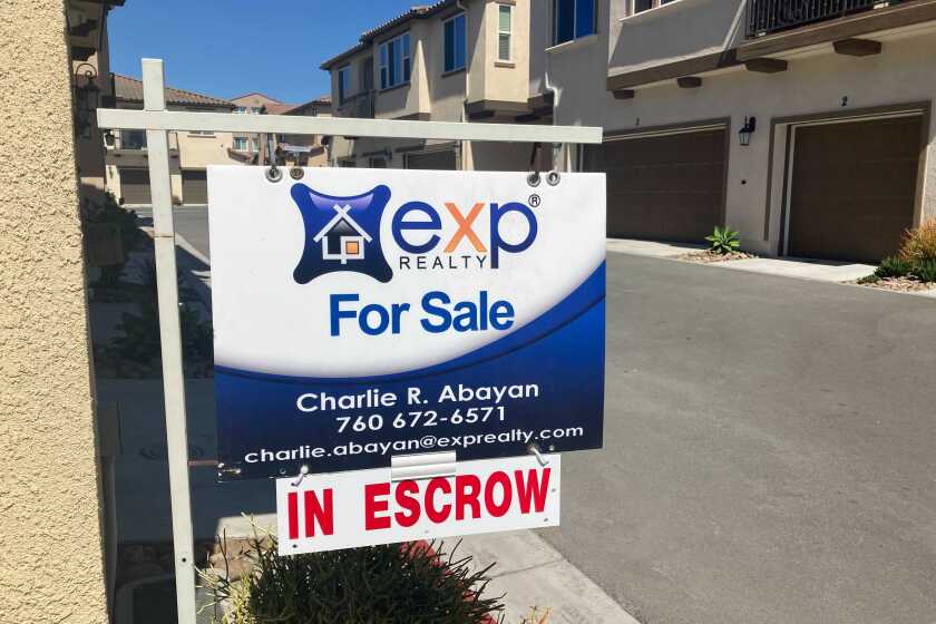 A for sale sign outside a Chula Vista townhouse.