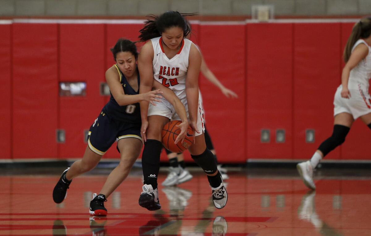 Huntington Beach's Marisa Tanga, right, steals the ball from Sonora's Maiya Wells during the first half in the Matt Denning Classic at Mater Dei High on Saturday.
