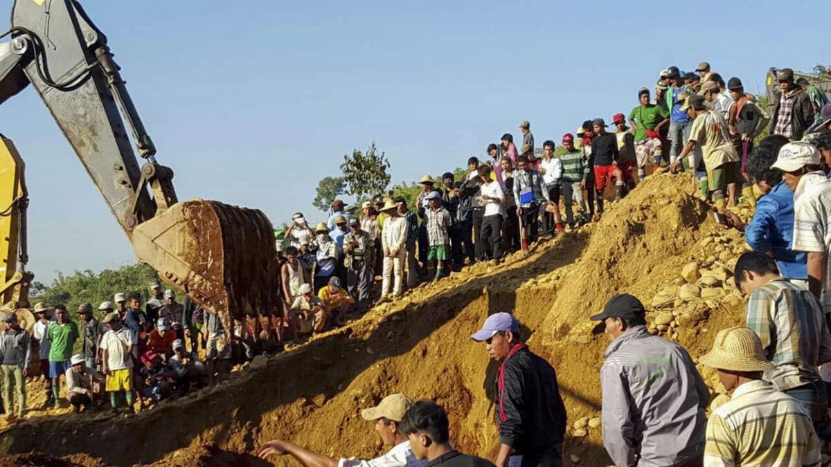 People search for victims of a landslide at the Hpakant jade mining area in northern Myanmar.