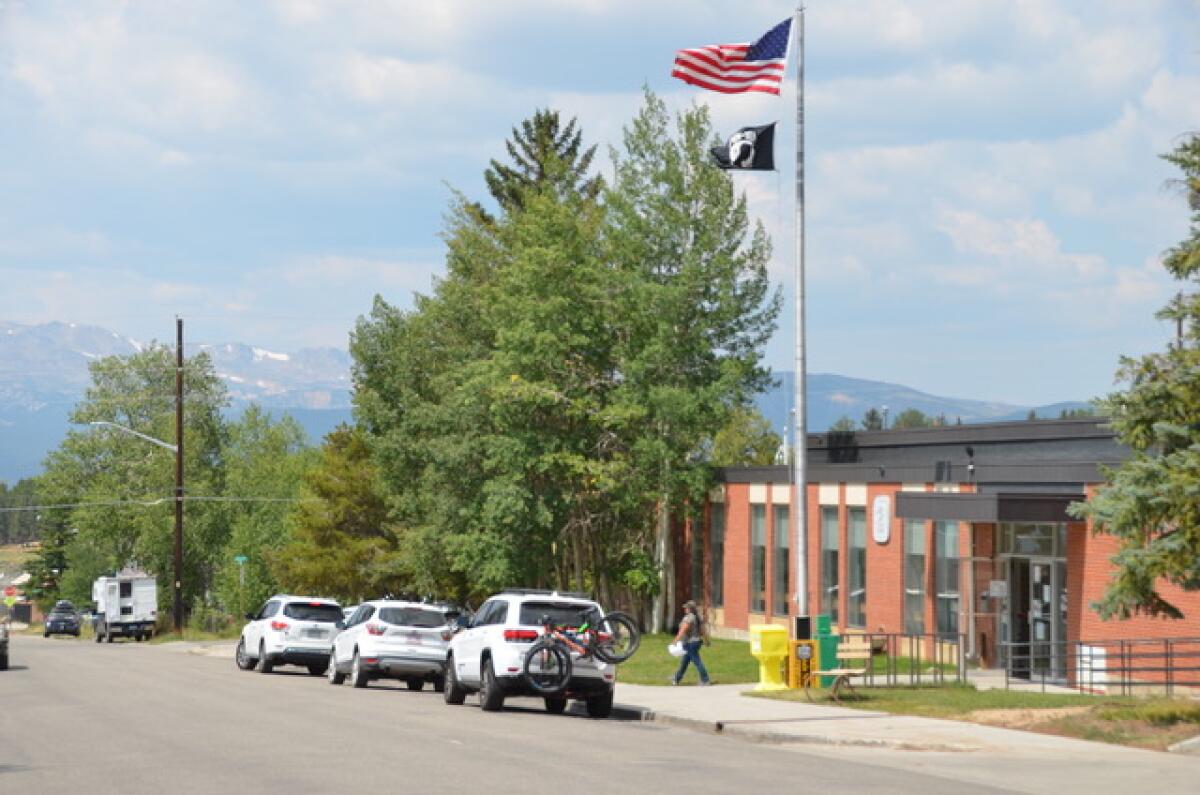 Snowy peaks, some exceeding 14,000 feet, loom above the post office in Leadville, Colo.