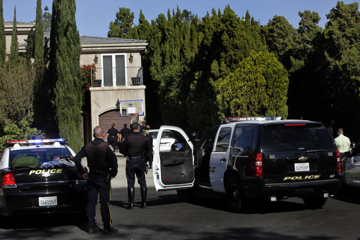 Police officers at the end of a chase on Roxbury Drive in Beverlywood.