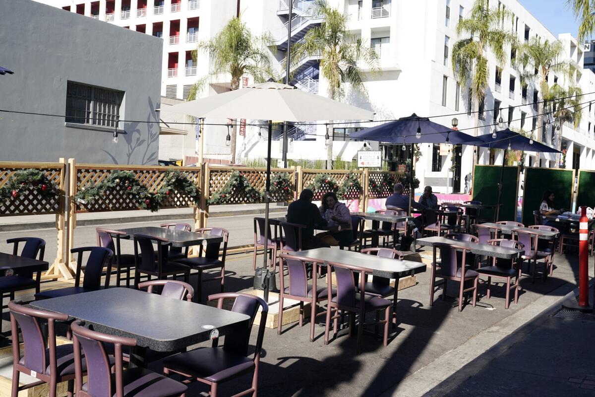 FILE - In this Dec. 4, 2020, file photo, empty tables are seen outside of a restaurant set up for outdoor dining in Burbank, Calif. Five California legislative assembly members dined together outdoors Monday, Dec. 8, 2020, despite surging coronavirus case levels that have triggered stay at home orders for much of the state's population. State rules are silent as to how many households can dine together outdoors at restaurants, but health officials have implored people to limit outside gatherings to no more than three households.(AP Photo/Marcio Jose Sanchez, File)