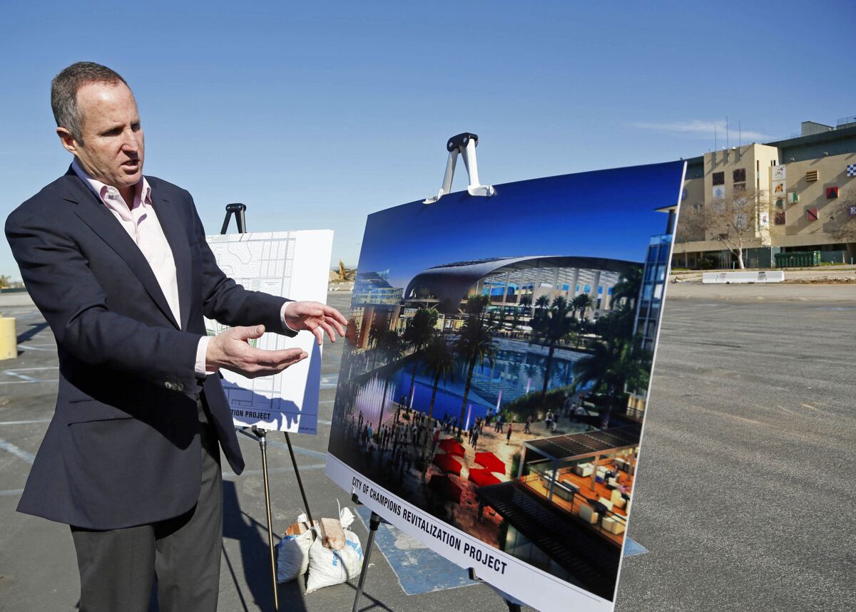 Chris Meany, senior vice president of Hollywood Park Land Company, shows an artist's rendering of a proposed NFL stadium at Hollywood Park in Inglewood.