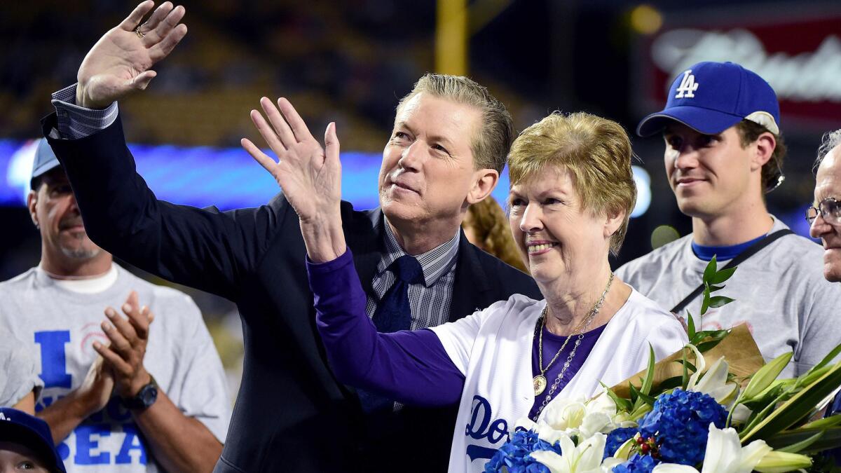 Dodgers organist Nancy Bea Hefley poses wth former star pitcher Orel Hershiser during an on-field ceremony before the team's game against the Padres on Friday night.