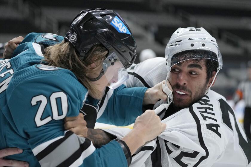 San Jose Sharks left wing Marcus Sorensen (20) fights with Los Angeles Kings left wing Andreas Athanasiou.