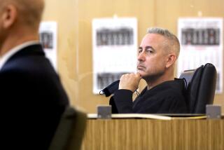 LONG BEACH-CA-JANUARY 19, 2022: Judge Daniel J. Lowenthal, right, listens as Long Beach Police Department Homicide Detective Ethan Shear takes the stand during a preliminary hearing in the case of Eddie F. Gonzalez, a former Long Beach School District safety officer charged with murder of a teen girl fleeing the scene of a fight, at Governor George Deukmejian Courthouse in Long Beach on Friday, January 19, 2022. (Christina House / Los Angeles Times)