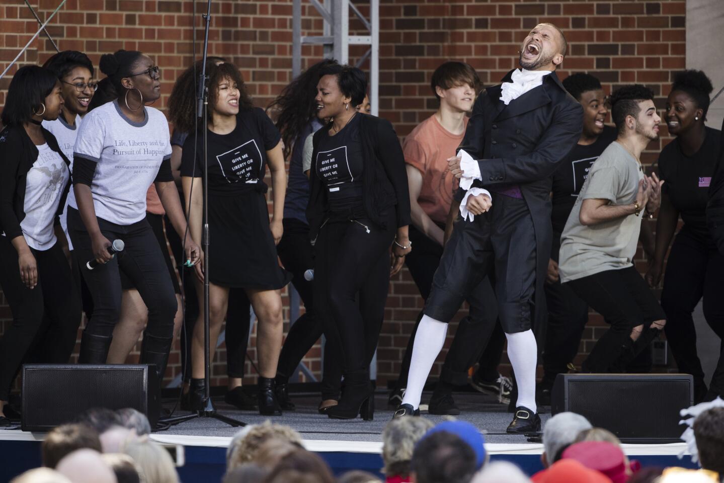 Sydney James Harcourt, an original cast member from the Broadway musical "Hamilton" performs with students from the Philadelphia High School for the Creative and Performing Arts during opening ceremonies for the Museum of the American Revolution in Philadelphia, Wednesday, April 19, 2017. For more about the museum, click here.