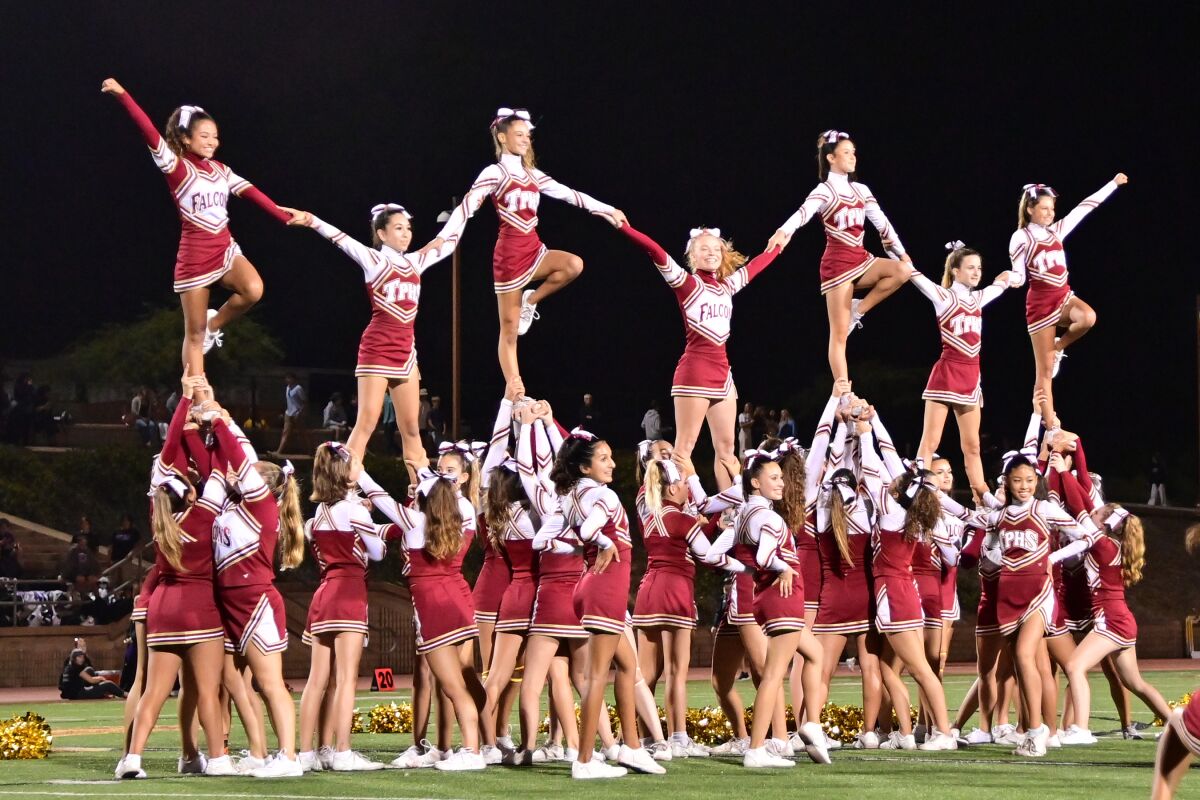The Torrey Pines cheer team performs at homecoming.