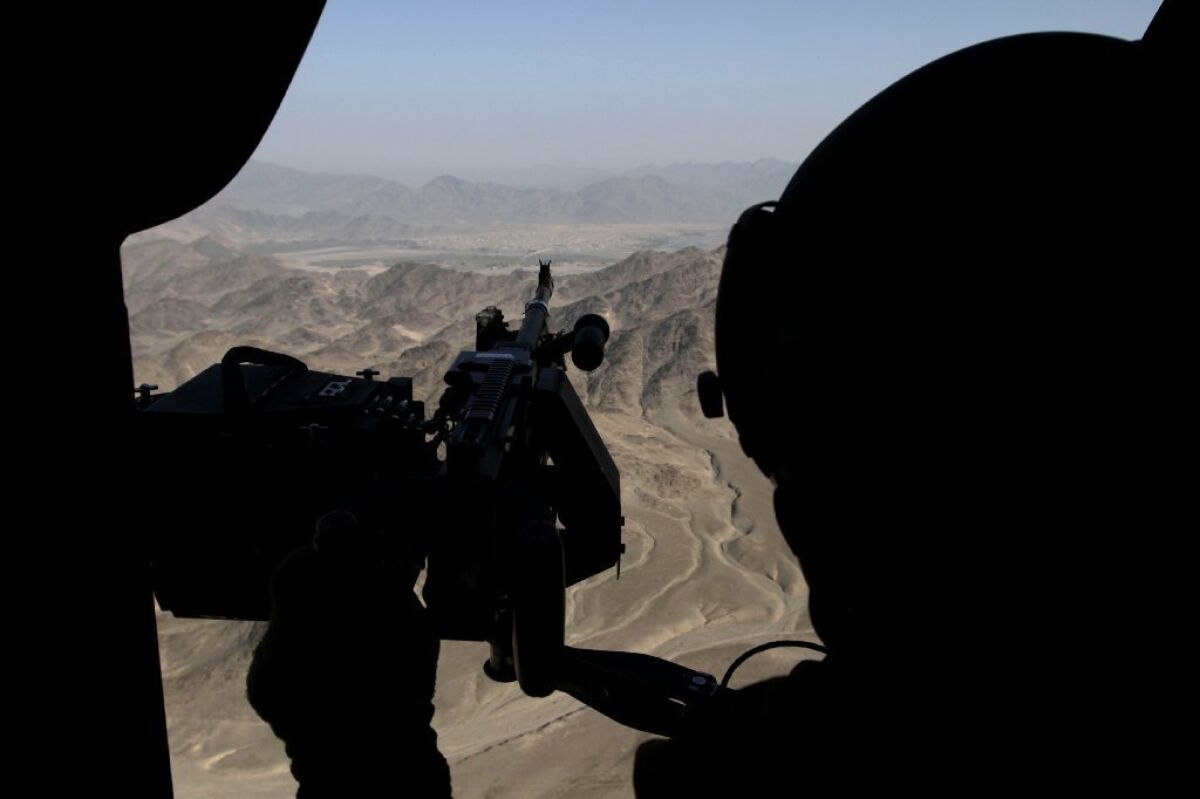 A U.S. soldier provides security from a helicopter during a flight near Jalalabad, Afghanistan.