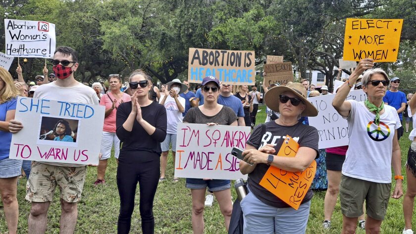 Supporters of abortion rights hold signs during a rally in St. Petersburg, Fla.