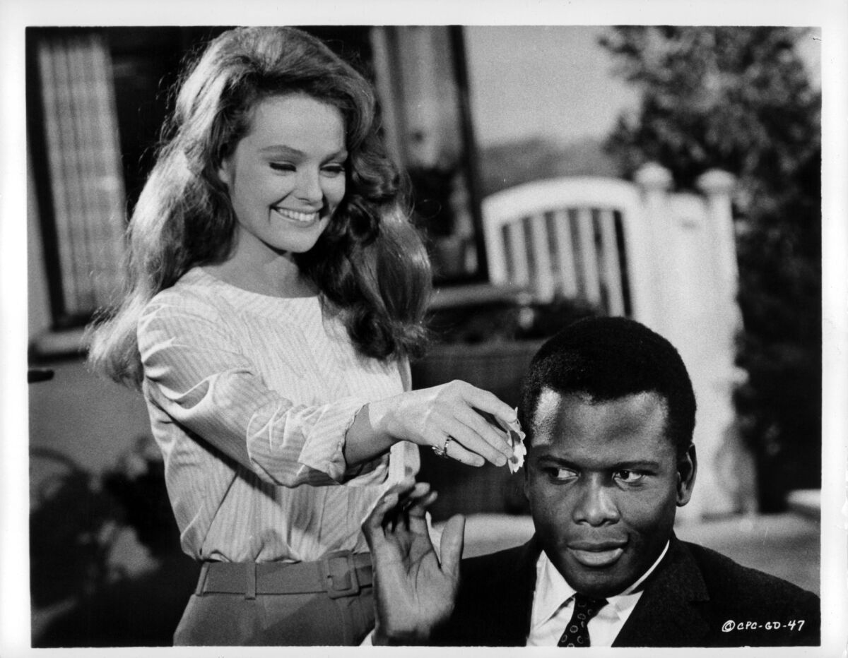 Katharine Houghton puts a flower in Sidney Poitier's hair in a scene from the 1967 film "Guess Who's Coming to Dinner."