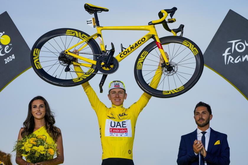 Tour de France winner Slovenia's Tadej Pogacar, wearing the overall leader's yellow jersey.