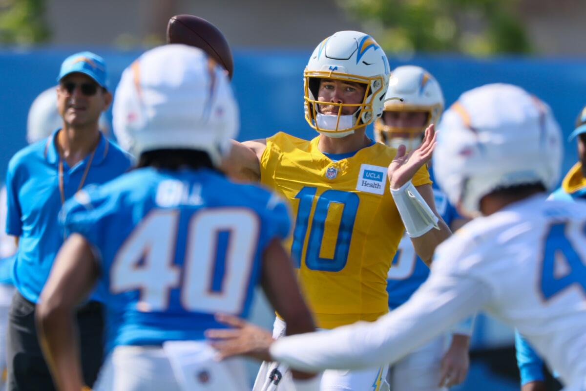 Quarterback Justin Herbert delivers a pass during the first day of Chargers' training camp.