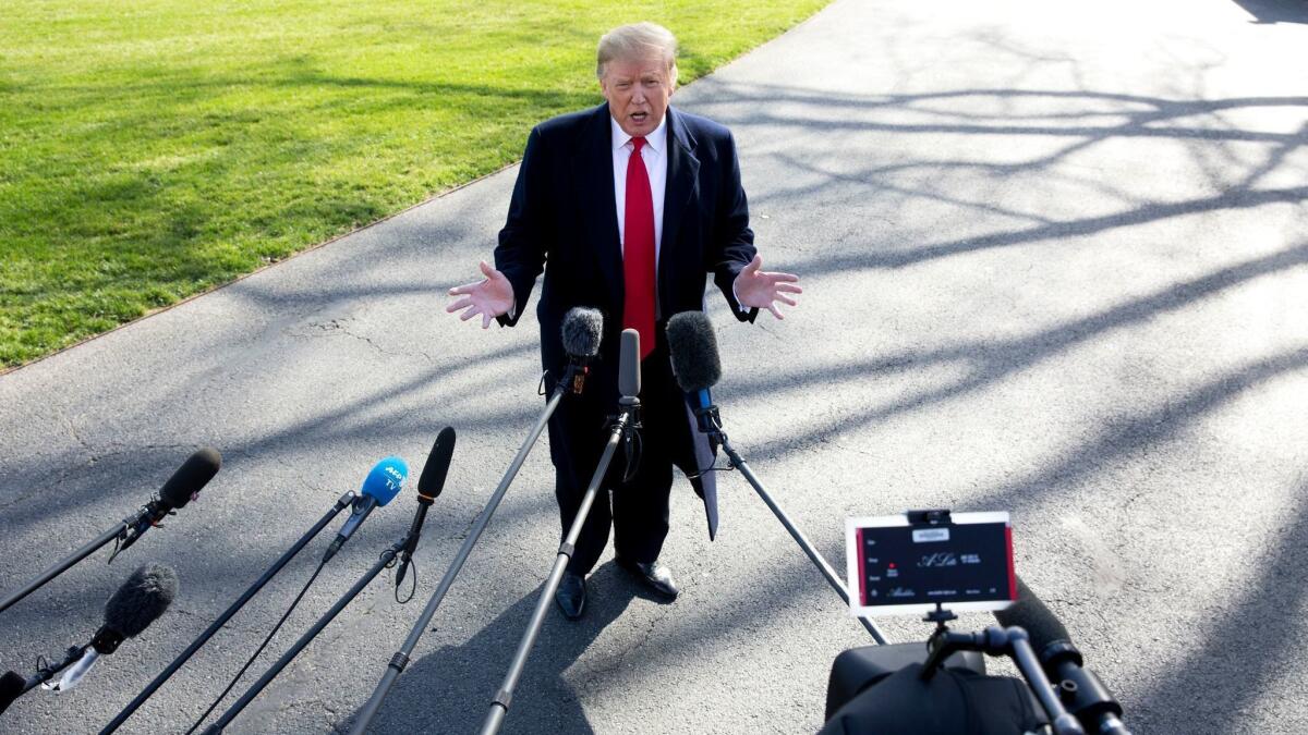President Trump talks to reporters outside the White House on March 28.