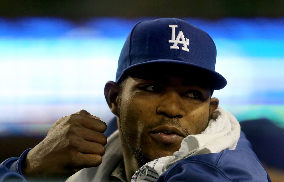 Dodgers outfielder Yasiel Puig watches the action from the dugout during a game against the Colorado Rockies on Sept. 15.