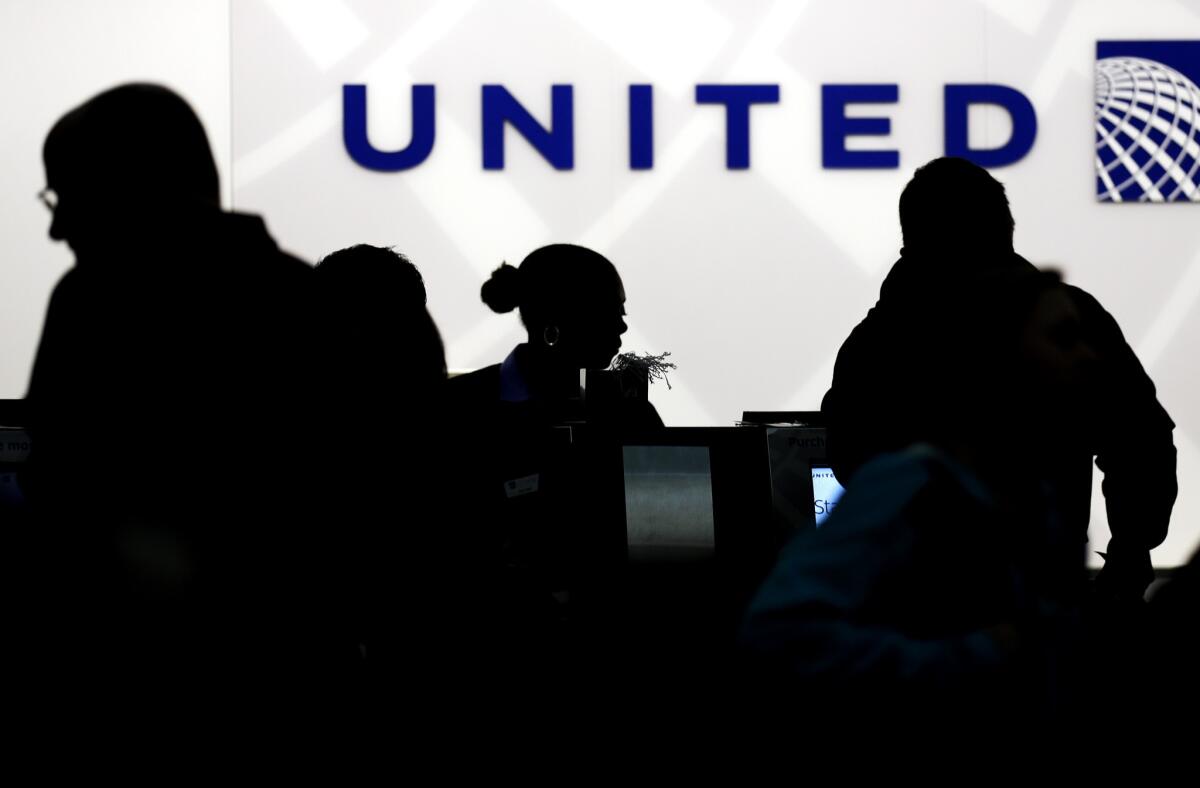 Travelers check in at the United Airlines ticket counter at Terminal 1 in O'Hare International Airport in Chicago. A computer problem led to delays Tuesday morning.