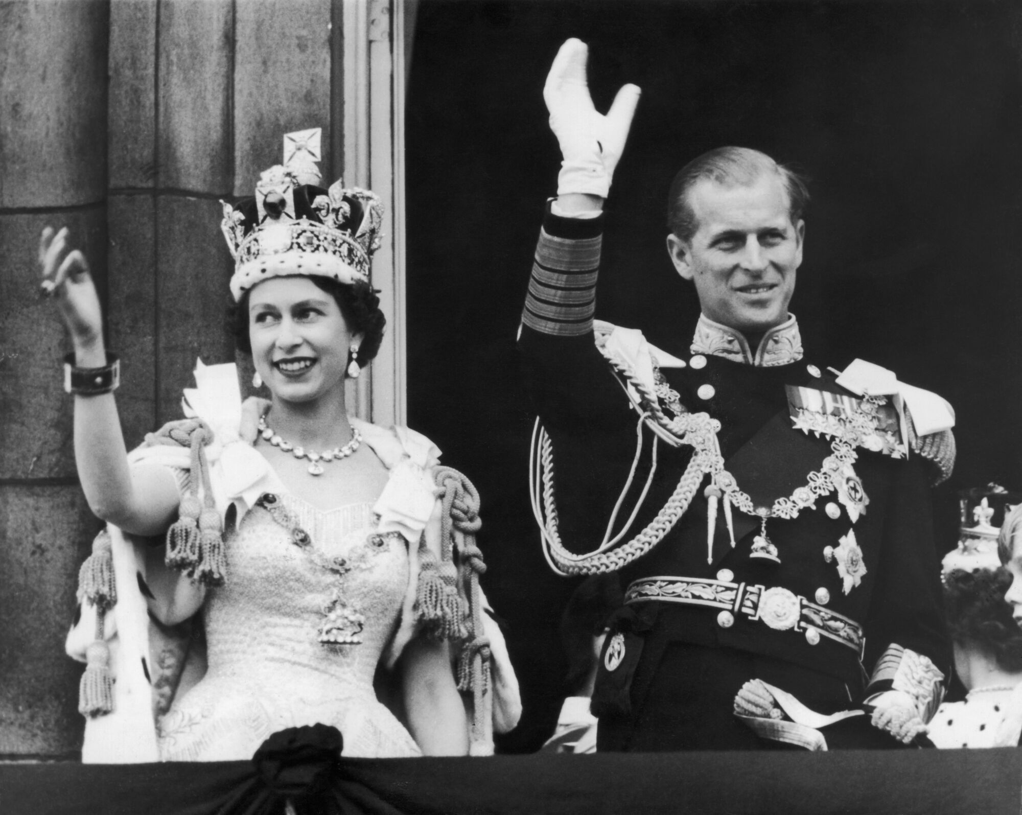 Queen Elizabeth II and the Duke of Edinburgh wave at the crowds from the balcony at Buckingham Palace 