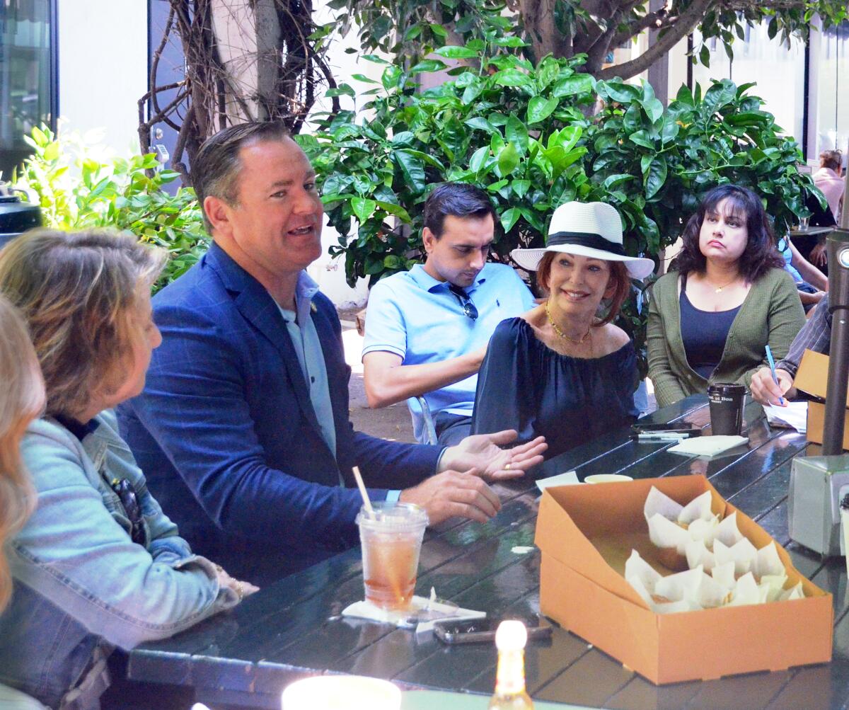 Newport Beach Mayor Will O'Neill speaks with residents during Coffee With the Mayor, held Wednesday at Haute Cakes Caffe.