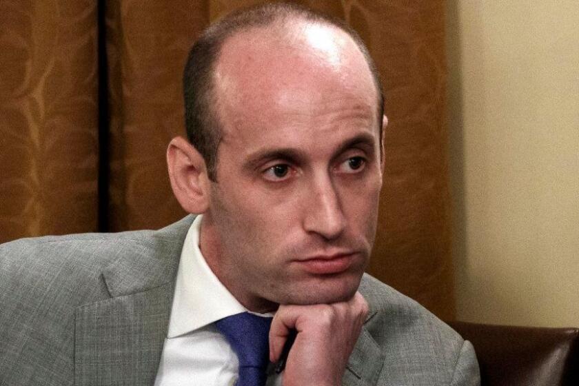 FILE - In this June 21, 2018 file photo, White House senior adviser Stephen Miller listens as President Donald Trump speaks during a cabinet meeting at the White House in Washington. A California school district has suspended a teacher who recounted how Miller ate glue as a third-grader. Nikki Fiske told the Hollywood Reporter that when Miller was a student in her Santa Monica, Calif., classroom, he was a loner with a messy desk who played with glue. The Los Angeles Times says the Santa Monica-Malibu Unified School District placed Fiske on "home assignment" while it decides what to do, if anything, about the disclosures. (AP Photo/Evan Vucci, File)