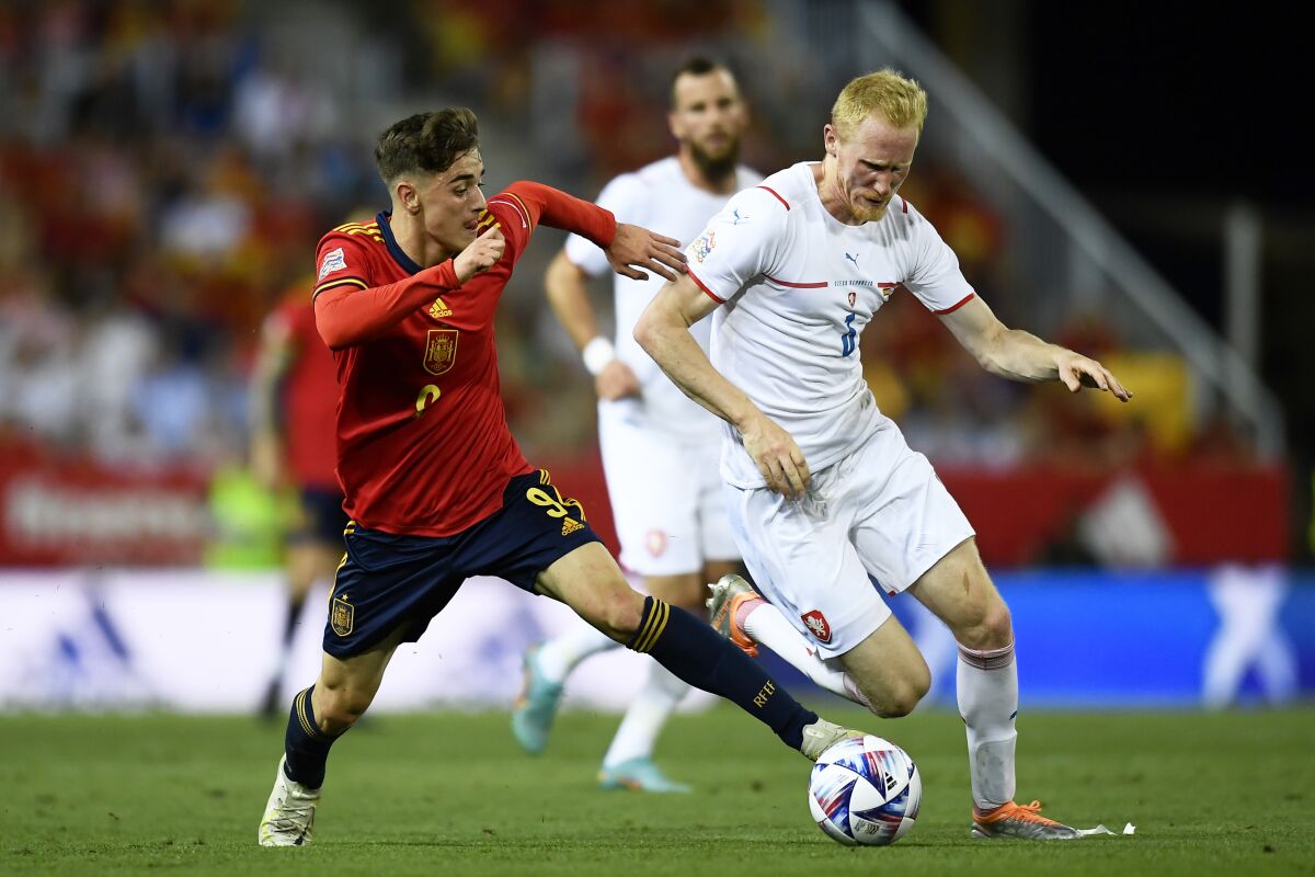 Spain's Gavi vies for the ball with Czech Republic's Vaclav Jemelka, right, during the UEFA Nations League soccer match between Spain and the Czech Republic, at La Rosaleda Stadium in Malaga, Spain, Sunday, June 12, 2022. (AP Photo/Jose Breton)