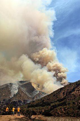 Photographers shoot the Morris fire, which began Tuesday afternoon near the Morris Dam north of Azusa.