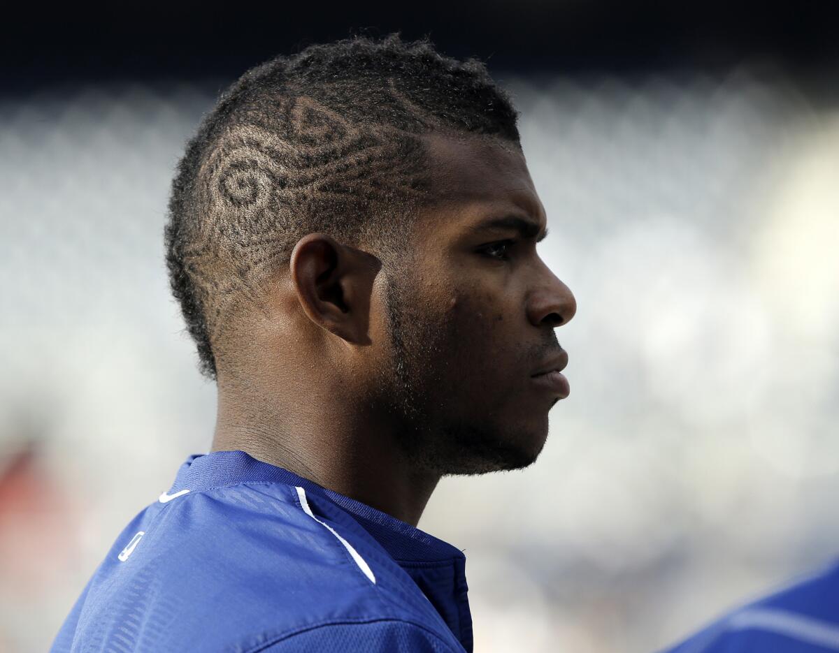 Dodgers outfielder Yasiel Puig waits for his turn to bat during warmups for a game against the Padres on May 21.