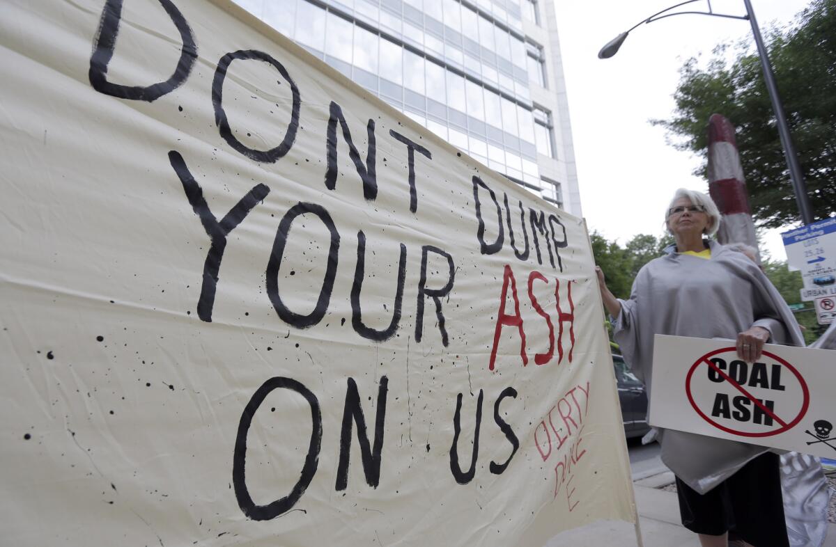 Debbie Hall of Sanford, N.C., protests May 7 outside Duke Energy headquarters before the company's shareholders meeting in Charlotte, N.C. Hall and other North Carolina residents worry about possible pollution from ponds the company uses to store coal ash.