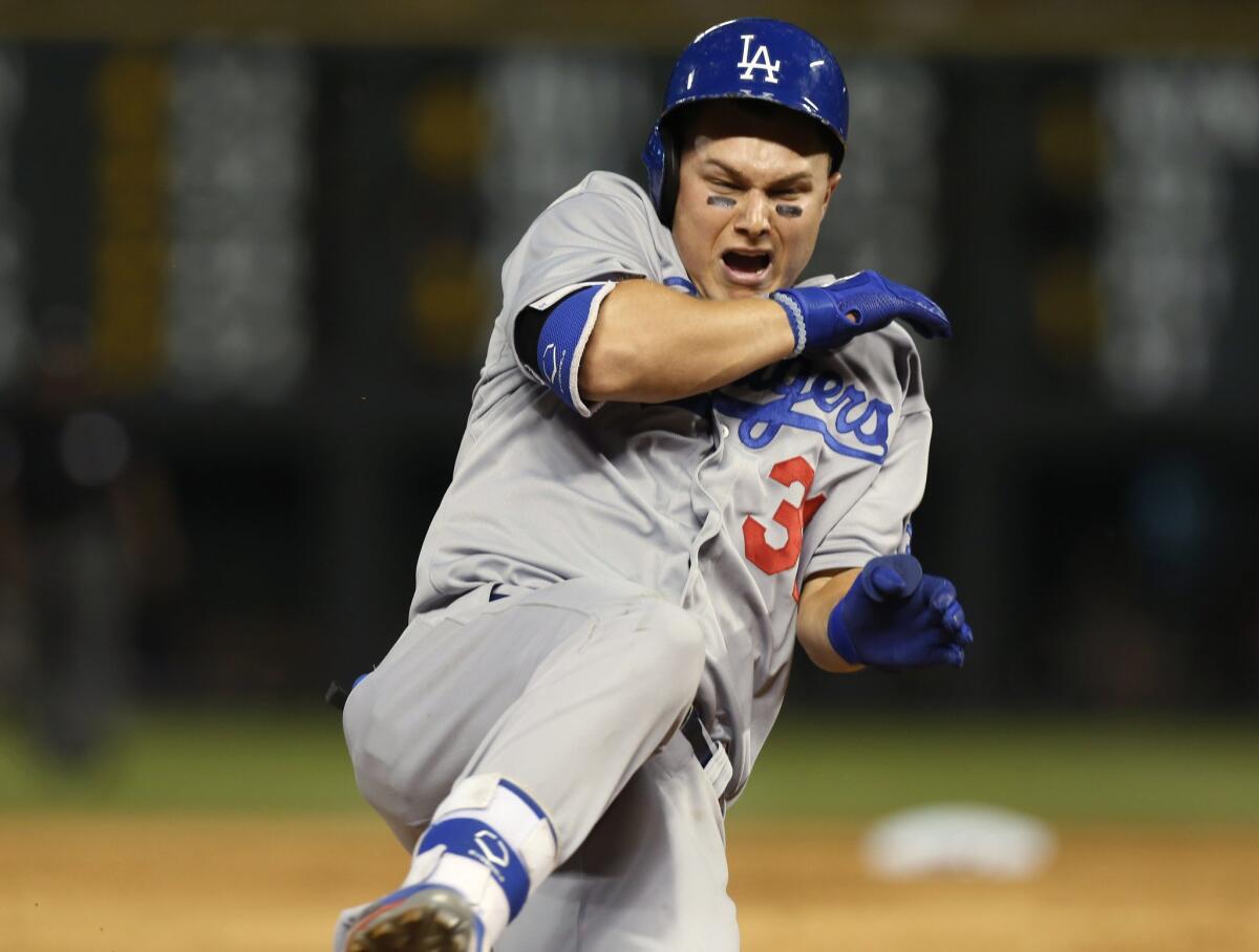 Joc Pederson slides into third after tripling on Tuesday.