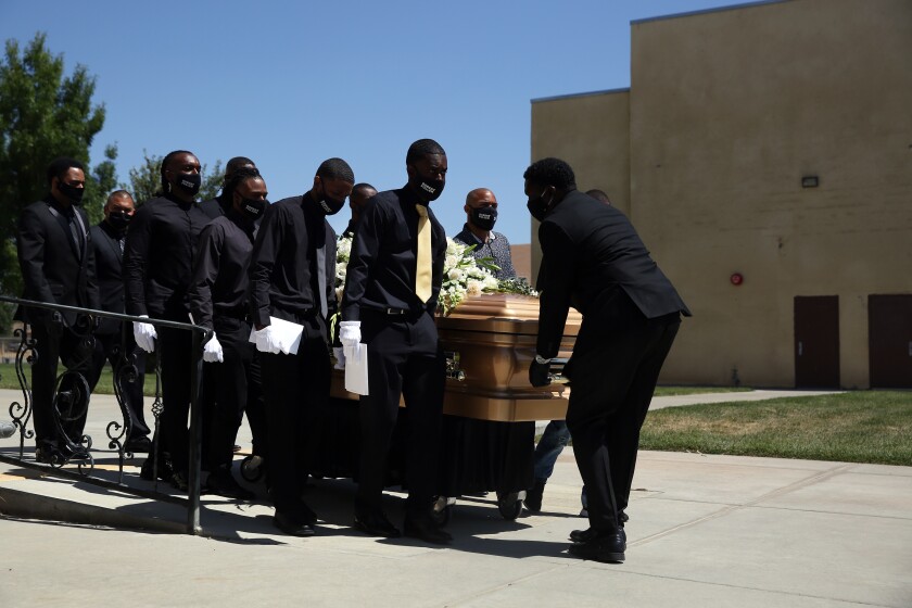 Pallbearers carry Robert Fuller's casket June 30 at Living Stone Cathedral of Worship in Littlerock, Calif.