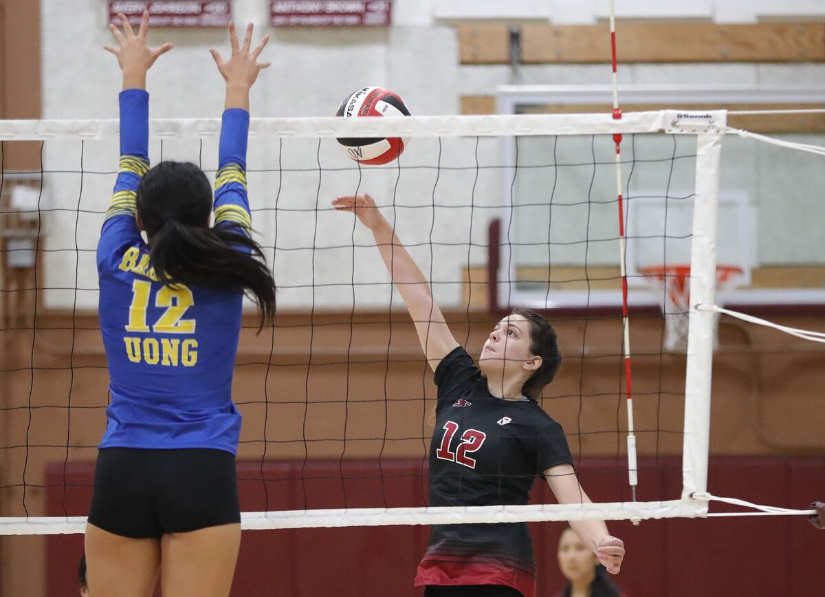 Ocean View's Mikayla Fields (12) sends a ball over a Fountain Valley blocker on Monday.