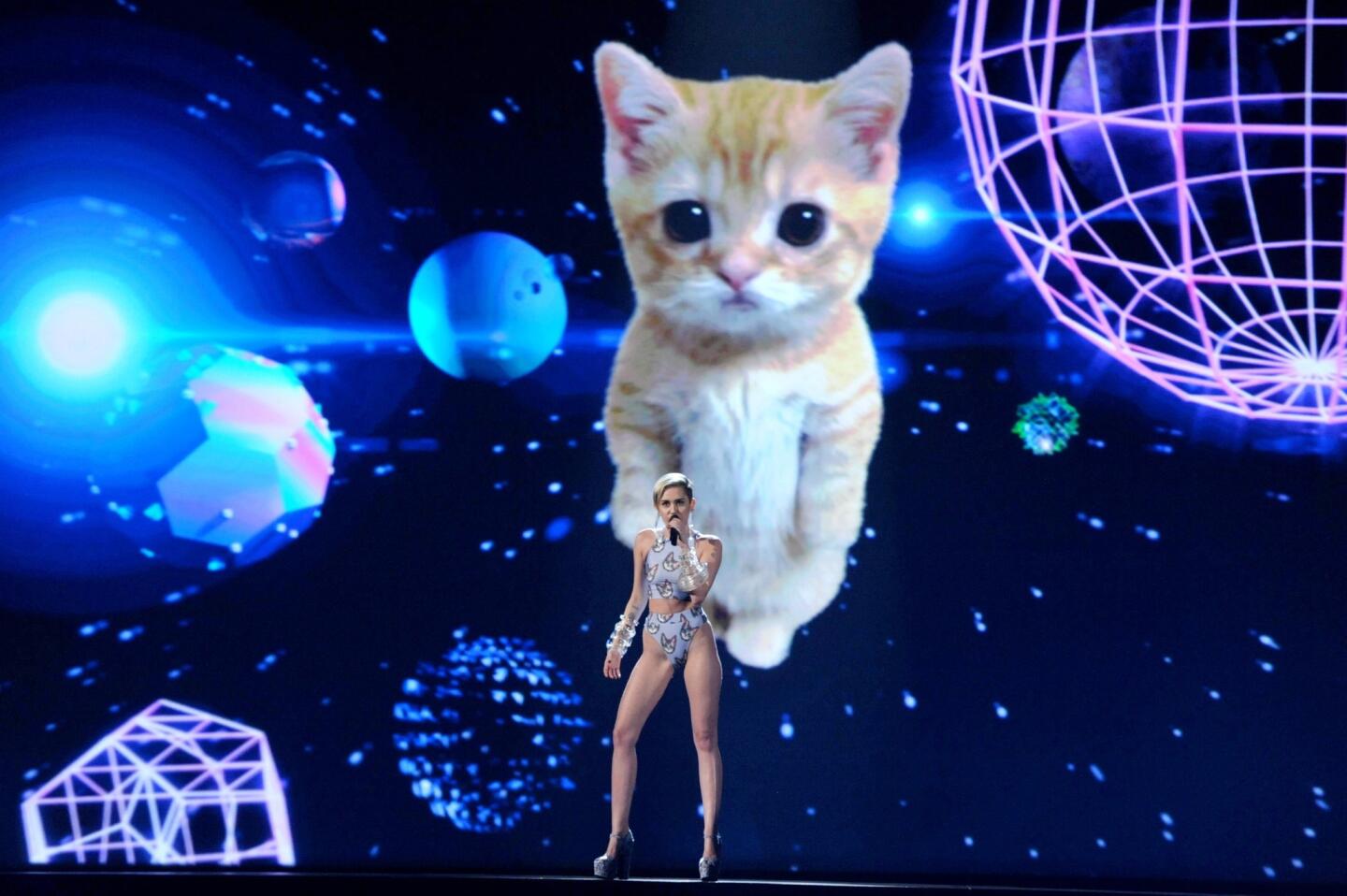 Just when we thought we had seen it all, Miley Cyrus pulls out a wild card during her performance of "Wrecking Ball" at the American Music Awards. It wasn't lewd gestures or a costume on the border of obscene — it was overwhelming cuteness. Because nothing says "heart wrenching" like a gigantic, floating space kitty, right?