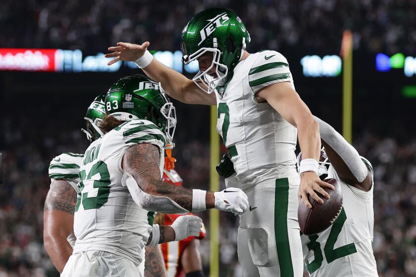 New York Jets quarterback Zach Wilson (2) celebrates with teammates after scoring a two-point conversion against the Kansas City Chiefs during the third quarter of an NFL football game, Sunday, Oct. 1, 2023, in East Rutherford, N.J. (AP Photo/Adam Hunger)