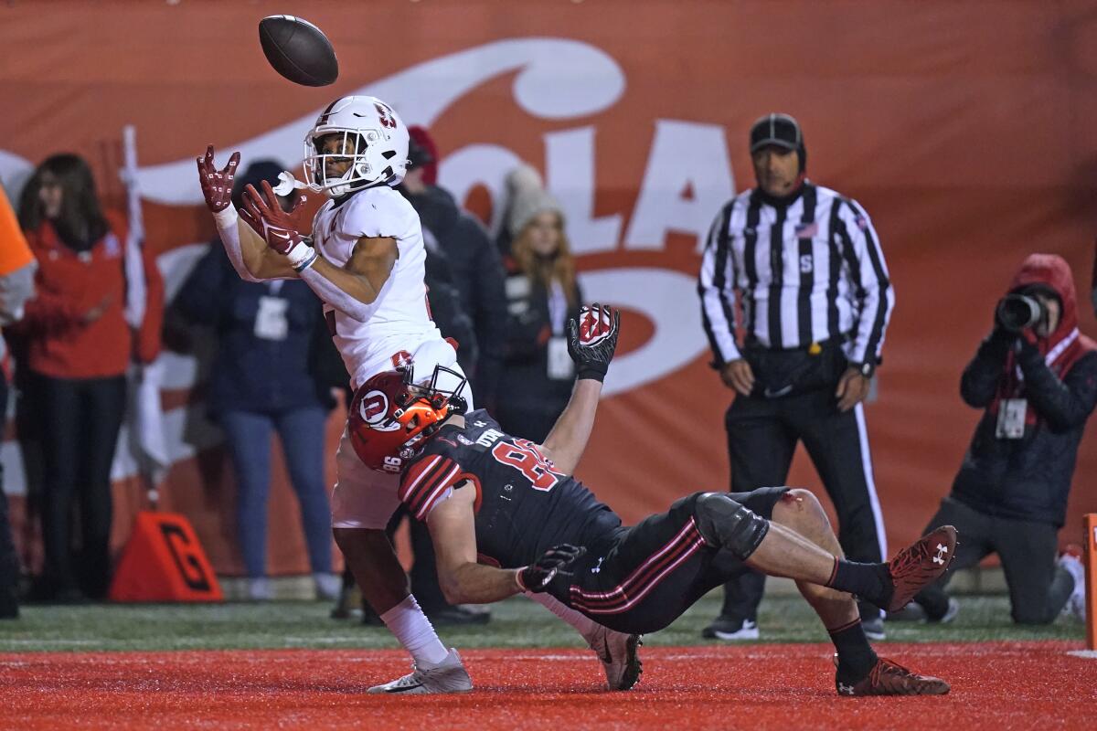 Stanford safety Jonathan McGill, left, makes an interception as Utah tight end Dalton Kincaid (86) falls during the first half of an NCAA college football game Saturday, Nov. 12, 2022, in Salt Lake City. (AP Photo/Rick Bowmer)