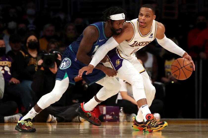 LOS ANGELES, CALIFORNIA - JANUARY 02: Russell Westbrook #0 of the Los Angeles Lakers handles the ball against Patrick Beverley #22 of the Minnesota Timberwolves during the first quarter at Crypto.com Arena on January 02, 2022 in Los Angeles, California. NOTE TO USER: User expressly acknowledges and agrees that, by downloading and or using this photograph, User is consenting to the terms and conditions of the Getty Images License Agreement. (Photo by Katelyn Mulcahy/Getty Images)