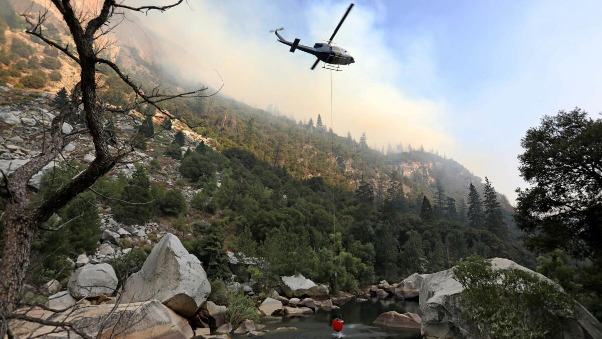 Helicopter crews work to stamp out the Ferguson fire as it burns along El Portal Road, a key entryway into Yosemite Valley on Aug. 13.