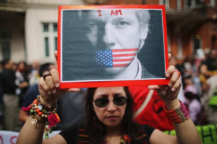 A Julian Assange supporter holds a sign outside the Ecuadorean Embassy in London in August 2012, a few weeks after Assange took refuge there.