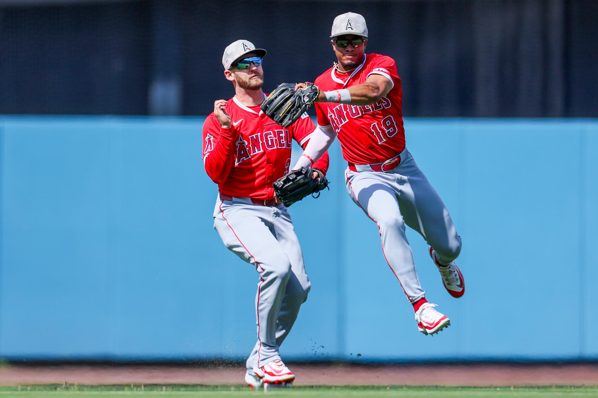 Angels center fielder Kyren Paris, right, narrowly avoids colliding with left fielder Taylor Ward.