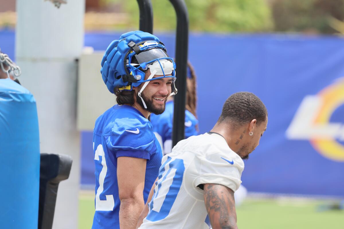 Rams receiver Puka Nacua, left, shares a laugh with teammate Tony Fields II on Tuesday.