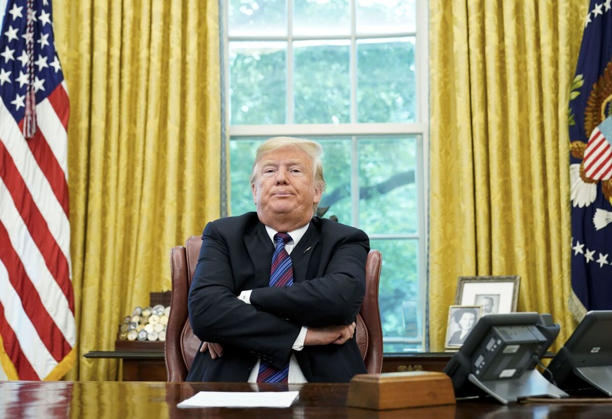 President Trump sits at the White House. 